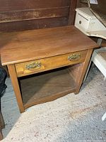Full view of washstand showing drawer, shelf, and overall form