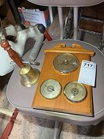 Overall view showing both the brass bell and the wood weather plaque