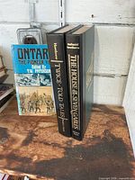 Spines of two Nathaniel Hawthorne hardcovers and Ontario history paperback