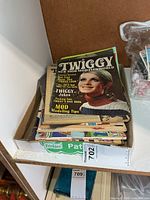 Stack of magazines in tray showing Twiggy cover