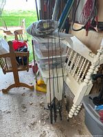 Full view of four fishing rods leaning together