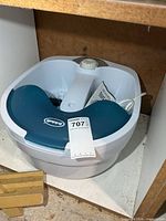 Overall view of foot spa under shelf