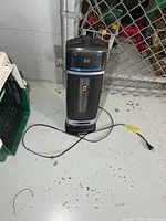 Front view of Lasko digital ceramic tower space heater with power cord visible