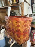 Overall view of woven wood basket hanging, shows color and handles