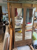 Front view showing two mirrored doors and bottom drawer