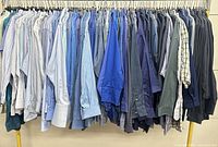 Full rack of blue men’s button-down shirts