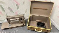 Singer 301A machine beside open hard case with pedal inside