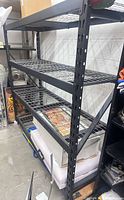 Full view of black 4-tier steel shelving with wire shelves