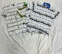 Three of the polo shirts laid out showing assorted prints and tags