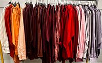 Full rack of assorted coloured men’s shirts on hangers