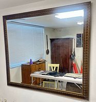 Full front view of large mirror mounted on wall