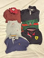 All six polo shirts laid out showing colour and style variations