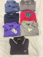 Stack of all seven folded polo shirts