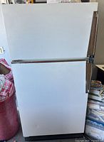 Front view of Amana white top-freezer refrigerator
