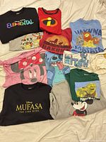 All nine shirts and sweatshirts laid out to show graphics and colours