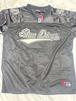 Front view of black San Diego jersey showing tag and embroidery