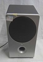Front view of Brookstone powered subwoofer showing grille and bass port
