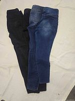 Four pairs of jeans side by side showing washes and length