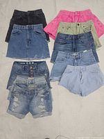 Group shot of all eight denim skirts and shorts arranged in four rows