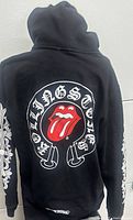 Back view showing Rolling Stones tongue graphic and Chrome Hearts lettering