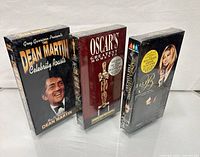 Front view of the three sealed VHS tapes standing upright