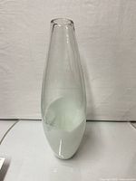 Full view of clear and white tapered glass vase