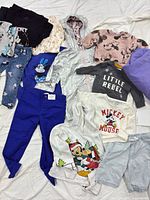 All 11 clothing items arranged on surface