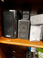 Front view showing glossy Duett, Sony, grey and white speakers