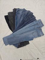 All ten pairs of jeans fanned out to show variety of washes