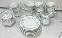 Full set showing cups, saucers, creamer and sugar bowl