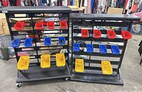 Front view of both metal parts racks with attached red, blue and yellow bins