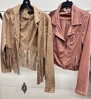 Front view of both jackets on hangers