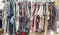 Rack holding approximately 38 assorted men’s short-sleeve button-down shirts