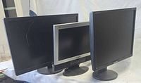 Front view of three monitors showing screen size and bezels