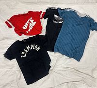 Group shot of all four shirts laid flat