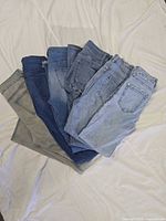 Stack of six jeans showing variety of washes
