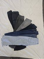 All seven pairs fanned out on white sheet showing assorted washes