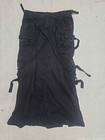Full view of front of black Tripp NYC goth skirt with chains and pockets