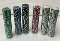 Front view of six vertical unopened chip stacks displaying all colors