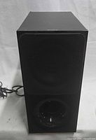 Front view of Sony SA-WCT390 subwoofer showing grille, bass port and attached power cord
