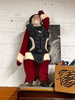 Front view of full Santa umpire figure with chest protector