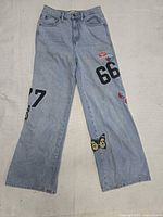 Full view of front of jeans showing patches and style