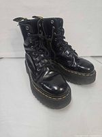 Three-quarter front view of both boots showing leather, laces, soles