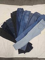 Ten pairs jeans fanned out showing colors