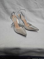 Full view of both silver rhinestone heels
