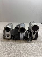 Front view of three Sony Handycam camcorders standing upright