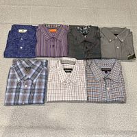 Seven shirts laid flat showing fronts