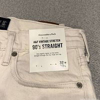 Close-up of waistband showing Abercrombie & Fitch hang tag and size 32W x 30L