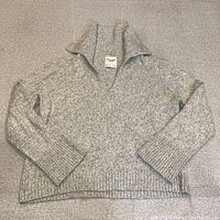 Full sweater laid flat showing overall style and condition