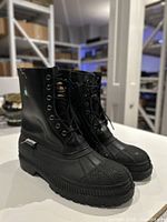 Side and front view of pair of black Baffin winter work boots